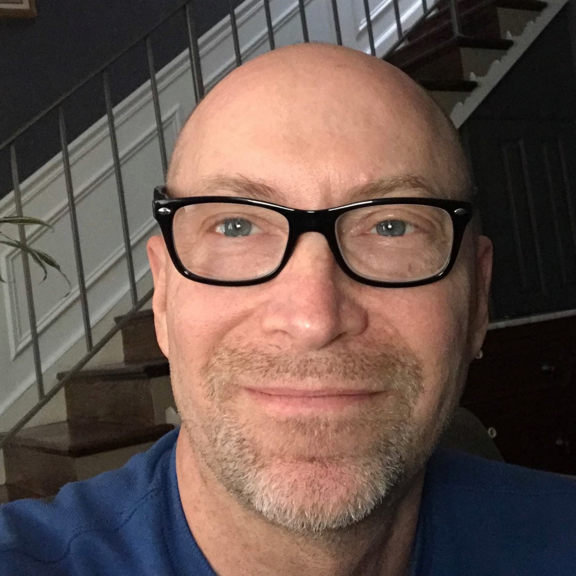 self portrait of Kevin Paul, wearing black eyeglasses.